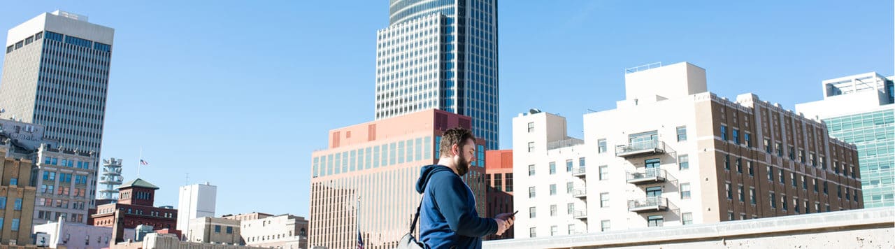 layout by flywheel responsive google map feature man on phone in front of skyline