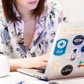 layout by flywheel how to create custom post templates wordpress woman working on laptop covered in stickers