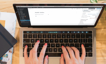 layout by flywheel get ready for gutenberg best wordpress update for content creators laptop with gutenberg editor on screen do your best work notebook and plant on wooden table
