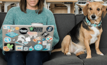 metrics to measure content success woman and dog on couch with laptop