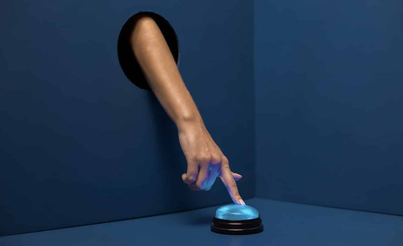 a person presses a blue light-up button
