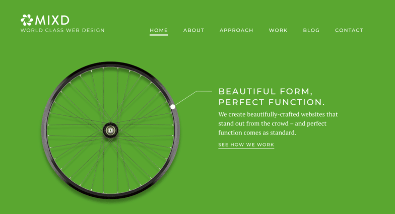 A screenshot of a homepage that's entirely green with white text, and the focal point is a wheel on the left side of the page. 