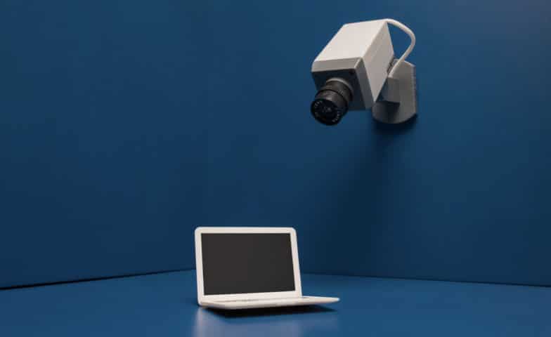 a security camera pointed at a laptop in a navy blue room
