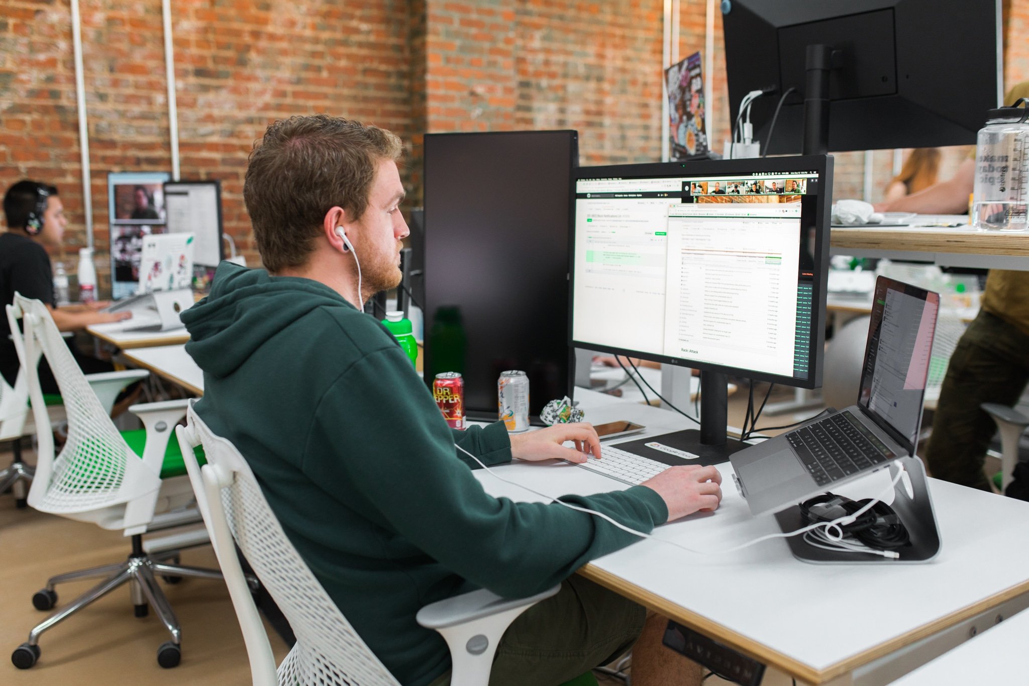 man working at a desk on a desktop computer