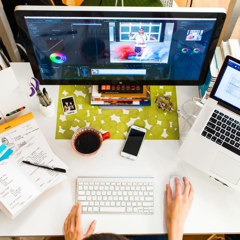 a designer works on color grading an image at a desk