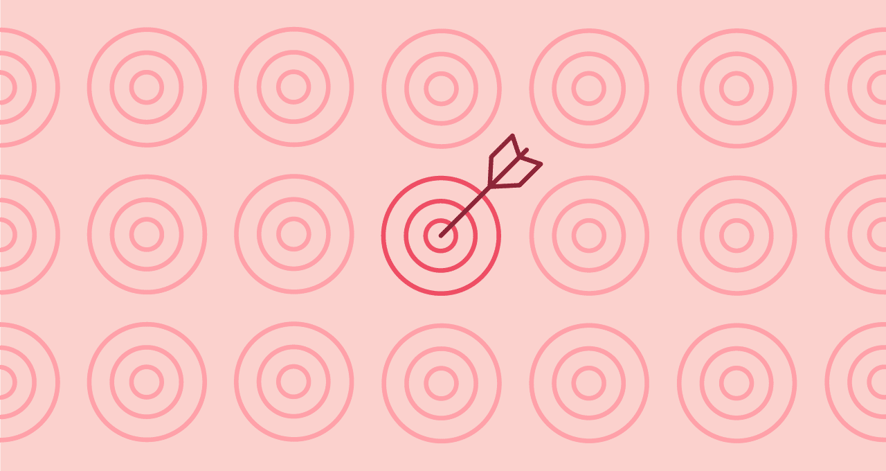 light pink background with pink targets, one red target in the center has a dark red arrow in the bullseye