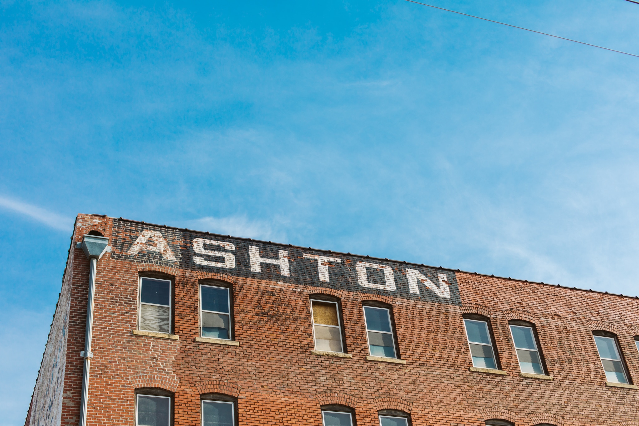 The brick exterior of the Ashton building. The word 