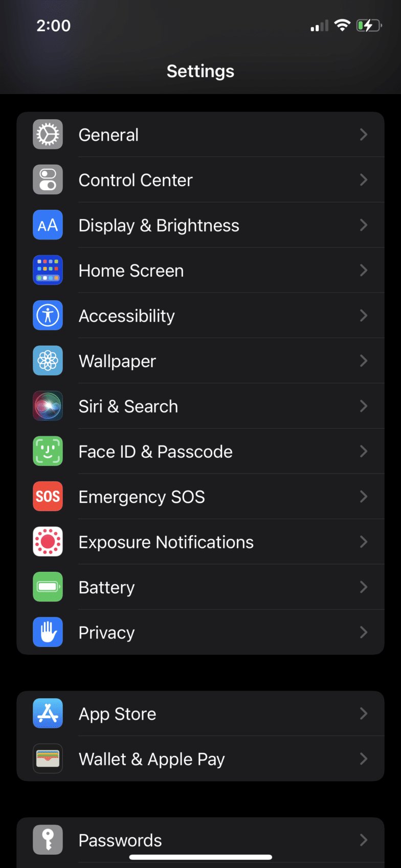 screenshot of Apple > General Settings on an iPhone 12 with dark mode enabled