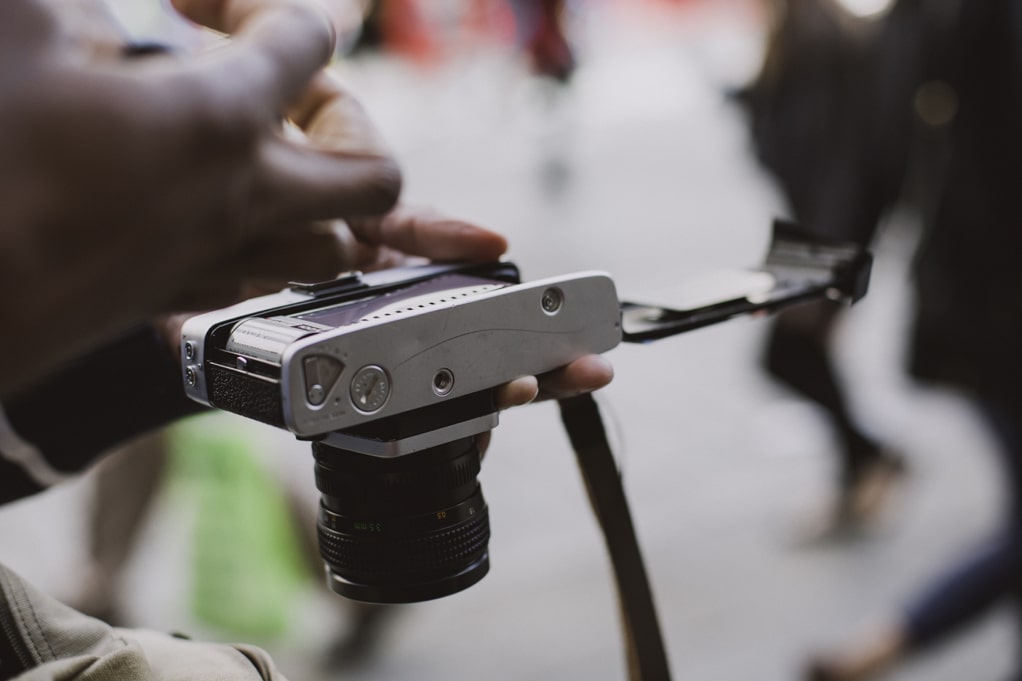 person loads film into a camera