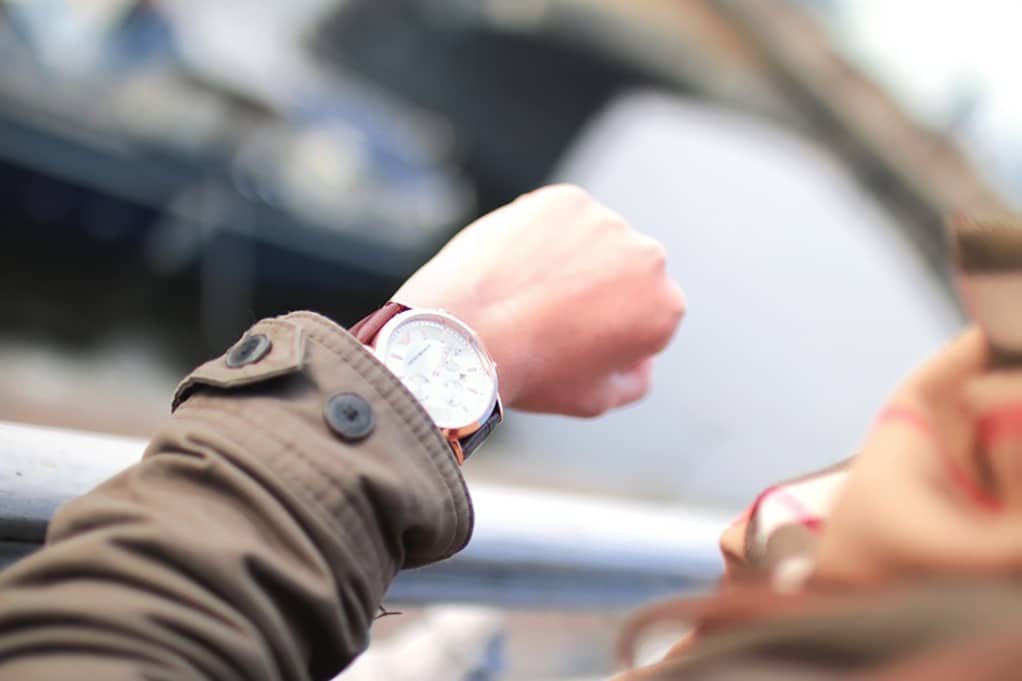 person's wrist with a watch on it, looking at the time