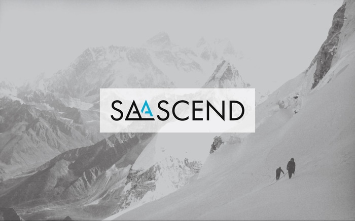 branded image shows SaaScend logo overlaid on an image of two hikers on a snowy mountainscape