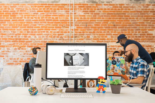 nosidebar website on desktop scene with toys on desk and flywheel happiness engineers nearby