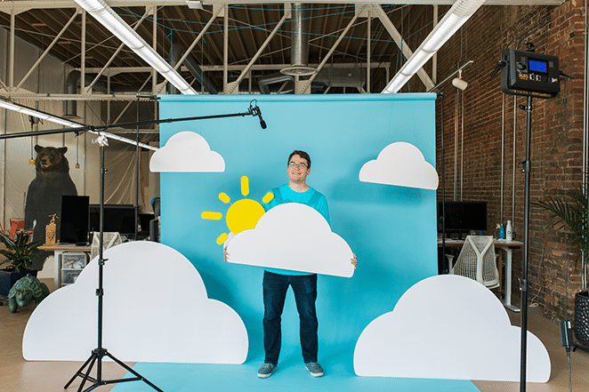 what is cloud hosting explained by flywheeler in cloud scene backdrop setup in flywheel coworking space in background